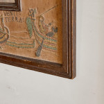 An unusual Arts & Crafts oak and embroidered mirror