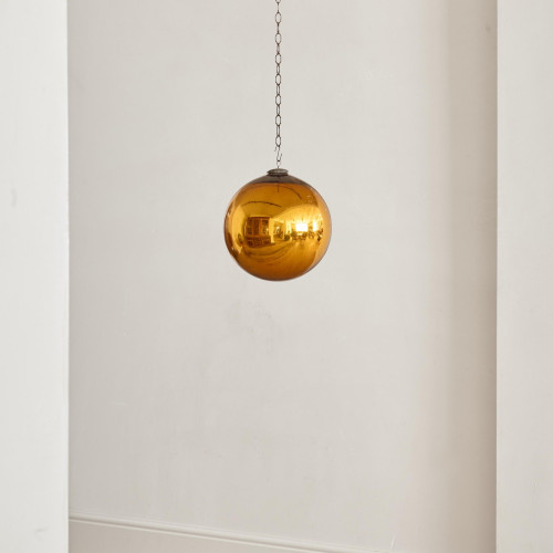 A Victorian amber glass witch's ball