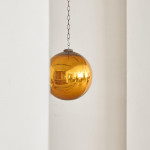 A Victorian amber glass witch's ball