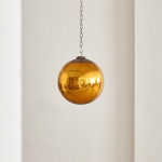 A Victorian amber glass witch's ball