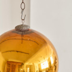 A Victorian amber glass witch's ball