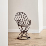 A riveted patinated metal garden chair