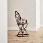 A riveted patinated metal garden chair