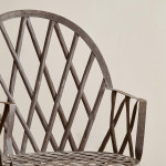 A riveted patinated metal garden chair