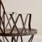 A riveted patinated metal garden chair