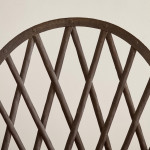 A riveted patinated metal garden chair