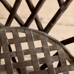 A riveted patinated metal garden chair