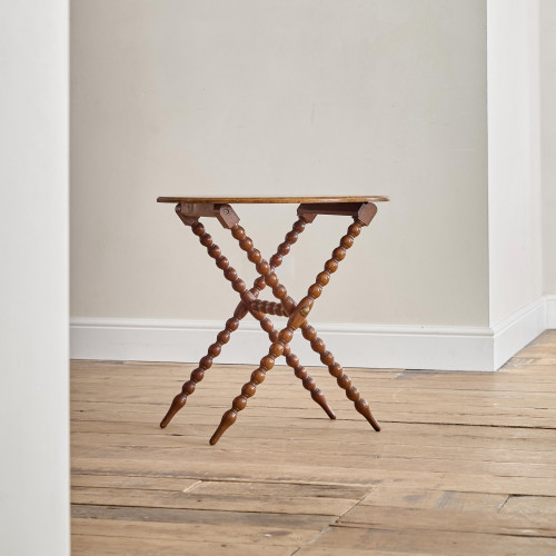 A Victorian walnut folding bobbin table