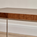 A rectangular steel and end-grain teak coffee table