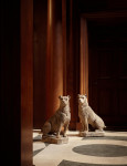 A pair of terracotta seated Boxer dogs by Mandeville et Combeleran