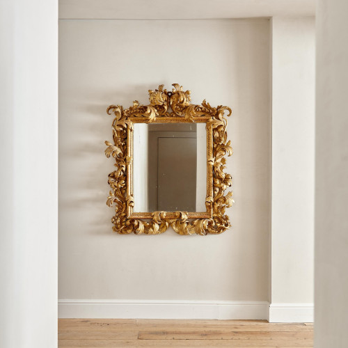 A fine and large carved and giltwood Baroque mirror in the manner of Filippo Passarini (1638 - 1698)