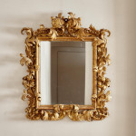 A fine and large carved and giltwood Baroque mirror in the manner of Filippo Passarini (1638 - 1698)
