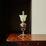 A model 394 silver-plated Arts & Crafts oil lamp on stand by W.A.S. Benson (1858 - 1924) with original vaseline glass shade by James Powell & Sons