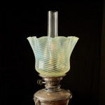 A model 394 silver-plated Arts & Crafts oil lamp on stand by W.A.S. Benson (1858 - 1924) with original vaseline glass shade by James Powell & Sons
