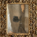 A Charles II embroidered wool and raised work framed mirror