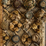 A Charles II embroidered wool and raised work framed mirror