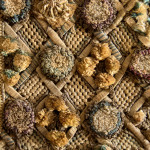 A Charles II embroidered wool and raised work framed mirror