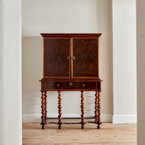 A fine William and Mary olivewood oyster veneered cabinet on stand