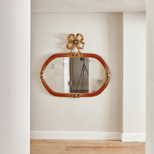 An 18th century carved parcel-gilt and red lacquered Venetian mirror
