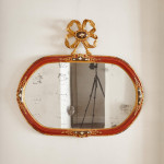 An 18th century carved parcel-gilt and red lacquered Venetian mirror