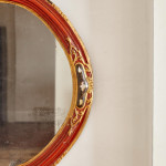 An 18th century carved parcel-gilt and red lacquered Venetian mirror
