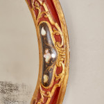 An 18th century carved parcel-gilt and red lacquered Venetian mirror