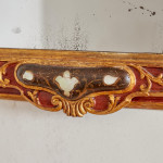 An 18th century carved parcel-gilt and red lacquered Venetian mirror