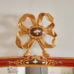 An 18th century carved parcel-gilt and red lacquered Venetian mirror