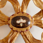 An 18th century carved parcel-gilt and red lacquered Venetian mirror