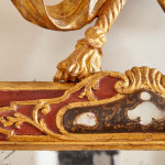 An 18th century carved parcel-gilt and red lacquered Venetian mirror