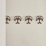 A collection of seven patinated wrought iron bridle hooks originally from Middleton Park, Oxfordshire