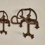 A collection of seven patinated wrought iron bridle hooks originally from Middleton Park, Oxfordshire