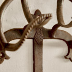 A collection of seven patinated wrought iron bridle hooks originally from Middleton Park, Oxfordshire