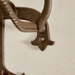 A collection of seven patinated wrought iron bridle hooks originally from Middleton Park, Oxfordshire