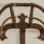 A collection of seven patinated wrought iron bridle hooks originally from Middleton Park, Oxfordshire