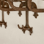 A collection of seven patinated wrought iron bridle hooks originally from Middleton Park, Oxfordshire