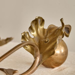 A pair of Arts & Crafts brass candlesticks after a design by W.A.S Benson