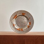 An Arts & Crafts hammered silver and copper plate