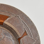 An Arts & Crafts hammered silver and copper plate