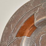 An Arts & Crafts hammered silver and copper plate