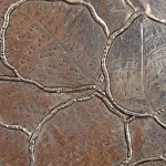 An Arts & Crafts hammered silver and copper plate