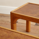 A pair of rectangular teak and leather low tables