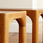 A pair of rectangular teak and leather low tables