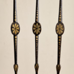 An ebonised and painted elbow chair