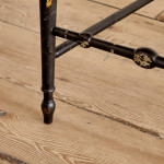 An ebonised and painted elbow chair