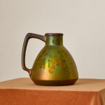 An iridescent glazed ceramic jug by Montières Pottery