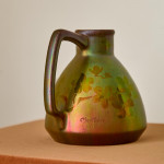 An iridescent glazed ceramic jug by Montières Pottery