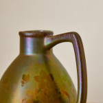 An iridescent glazed ceramic jug by Montières Pottery