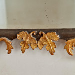 A rectangular mirror with an ebonised and parcel gilt carved frame