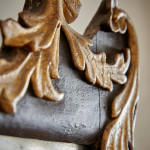 A rectangular mirror with an ebonised and parcel gilt carved frame